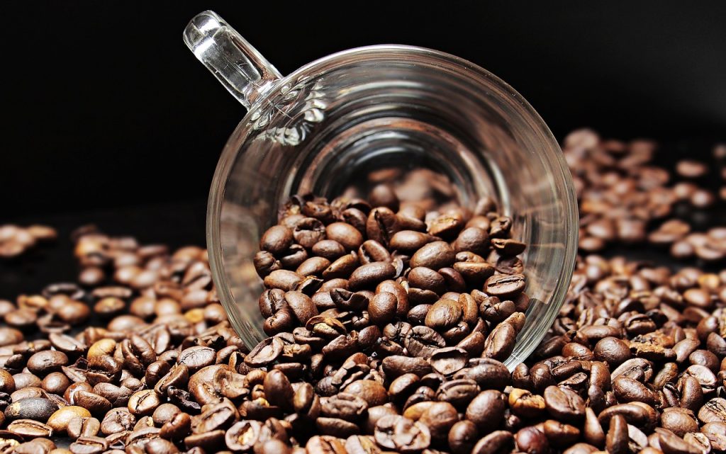 An image capturing the essence of SL-34 Coffee Beans: a close-up of a steamy cup, showcasing a rich caramel-colored brew with delicate hints of citrus, an inviting aroma swirling in the air